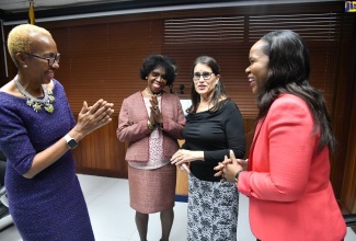 Minister of Education and Youth, Hon. Fayval Williams (left), shares pleasantries with Chief Education Officer (Acting), Dr. Kasan Troupe (right), during the launch of the Inter-American Development Bank’s (IDB) Teachers’ Digital Skills Project. The ceremony was held at the Education Ministry’s offices in Kingston on Wednesday (October 4). Sharing the moment are (from second left) Chief Executive Officer, Jamaica Teaching Council, Dr. Winsome Gordon, and Senior Director, International Society for Technology in Education (ISTE) Standards, Carolyn Sykora.


