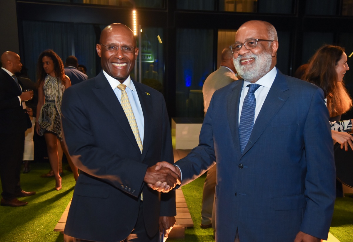 Minister of Industry, Investment and Commerce, Senator Hon. Aubyn Hill (left), shakes hands with General Manager, Country Department Caribbean Group and Country Representative, Jamaica, Inter-American Development Bank (IDB), Anton Edmunds, during the IDB’s Sub-Regional Policy Dialogue network forum cocktail reception at the AC Hotel by Marriott Kingston on Wednesday (October 18).

