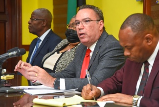 Minister of Science, Energy, Telecommunications and Transport, Hon. Daryl Vaz (second right), addresses a press conference held at the Ministry’s Maxfield Avenue offices on Tuesday (October 24). Also pictured (from left) are Transport Authority Chairman, Owen Ellington; Permanent Secretary in the Ministry, Carol Palmer; and Transport Authority Managing Director, Ralston Smith.

 