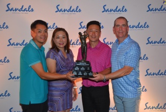 The Confidence Travel team, winners of the Sandals 27th Annual Baxter Canadian Golf Tournament. Members include (from left) Leo Tam, Wendy Hsu, Tom Liu and Chris Gregoris. Occasion was the dinner & awards ceremony, held  at Sandals Ochi in St. Ann on October 28.