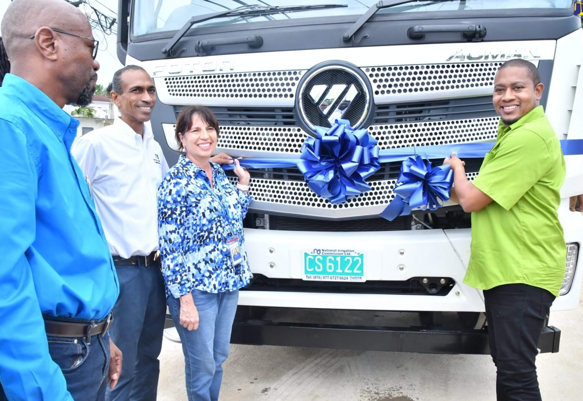 Minister of Agriculture, Fisheries and Mining, Hon. Floyd Green (right), cuts the ribbon to officially hand over a water truck in Clarks Town, Trelawny . Occasion was a commissioning ceremony for the truck, a ramp and pumping station on Thursday (October 5). Sharing the moment are (from left) Chief Executive Officer at the National Irrigation Commission (NIC), Joseph Gyles; Chairman of the NIC Board, Nigel Myrie and Board Member at the NIC, Genille Attalla.