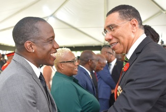 Prime Minister, the Most Hon. Andrew Holness (right), congratulates entertainer, Wayne “Wayne Marshall” Mitchell (left), who was conferred with the Order of Distinction in the rank of Officer, for contribution to the field of entertainment in particular reggae music. Occasion was the Ceremony of Investiture and Presentation of National Honours and Awards, held on the lawns of King’s House on Monday (October 16). 