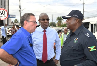 Minister of Science, Energy, Telecommunications and Transport, Hon. Daryl Vaz (left), is in conversation with Head of the Jamaica Constabulary Force (JCF) Public Safety and Traffic Enforcement Branch (PSTEB), Assistant Commissioner of Police (ACP) Gary McKenzie (right) and Chairman of the Transport Authority (TA), Owen Ellington. Occasion was a tour of sections of the Corporate Area on Monday (October 9), as part of activities under ‘Operation Streamline,’ which aims to  rid the streets of rogue taxi drivers.