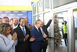 Deputy Prime Minister and Minister of National Security, Hon. Dr. Horace Chang (second right), cuts the ribbon to open the new Courts Parkway Square store in Portmore, St. Catherine, during the private launch on October 11. Sharing in the moment are (from left) Minister without Portfolio in the Office of the Prime Minister with responsibility for Skills and Digital Transformation, Senator Dr. the Hon. Dana Morris Dixon; Minister of State in the Ministry of Foreign Affairs and Foreign Trade, Alando Terrelonge; and Chief Executive Officer and Chairman of Unicomer Group, the parent organisation for Courts, Mario Simon.