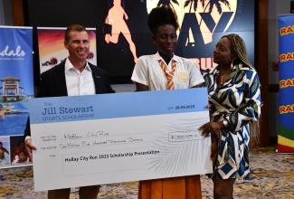 A tearful Rhianna Lewis, a grade-11 student of Rhodes Hall High School in Hanover (centre), accepts the inaugural Jill Stewart Sports Scholarship from Executive Chairman of Sandals Resorts International, Adam Stewart (left) and Founder of MoBay City Run, Janet Silvera. Occasion was the MoBay City Run scholarship awards ceremony held recently at Sandals Montego Bay in St. James. 

 