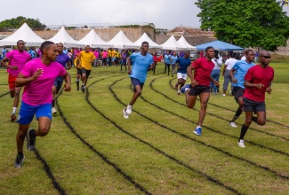 Department of Correctional Services (DCS) staff participate in a race during the entity’s Sports Day and Expo, held at the St. Catherine Adult Correctional Centre Sports Club on Friday (October 27).

