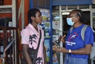 Medical Officer of Health for Westmoreland, Dr. Marcia Graham (right), engages with Daniel Montaque during a dengue-prevention public education campaign in Little London in the parish on Friday (September 29)