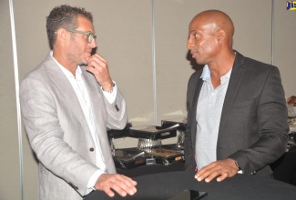 Caption: American Travel Writer, Doug Lansky (left) discusses tourism opportunities with former Jamaica Hotel and Tourist and Association (JHTA) President, Omar Robinson, at a Jamaica Tourism Awareness Week 2023 symposium, held at the Hyatt Ziva Hotel on September 28.