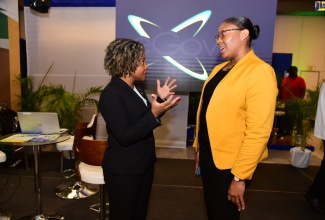 Minister without Portfolio in the Office of the Prime Minister with Responsibility for Skills and Digital Transformation, Senator Dr. the Hon. Dana Morris Dixon (left), speaks with Acting Chief Executive Officer of eGov Jamaica Limited, Anika Shuttleworth, during today’s (November 29) second annual Government of Jamaica (GOJ) Technology Showcase at the AC Hotel in New Kingston.