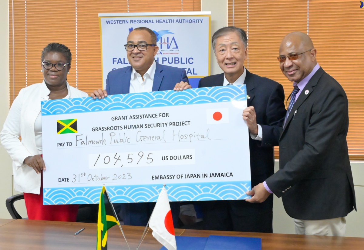 Minister of Health and Wellness, Hon. Dr. Christopher Tufton (second left), and Ambassador of Japan to Jamaica, His Excellency Yasuhiro Atsumi (second right), display the cheque for the purchase of an ambulance for the Falmouth Public General Hospital in Trelawny, during a ceremony held at the Ministry’s New Kingston offices on Tuesday (October 31). Sharing the moment (from left) are Chief Executive Officer of the hospital, Princess Wedderburn; and Regional Director for the Western Regional Health Authority (WRHA), Andrade Sinclair.