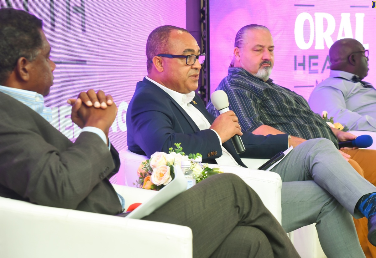 Health and Wellness Minister, Dr. the Hon. Christopher Tufton (second left), speaks during a virtual Diaspora townhall held at The Jamaica Pegasus hotel in New Kingston on Monday (October 30), in observance of Oral Health Month. The event was hosted by the Health Ministry. Listening are (from left) Executive Director, National Healthcare Enhancement Foundation Ltd., Courtney Cephas; Executive Director, Great Shape Inc., Joseph Wright; and Chief Dental Officer, Ministry of Health and Wellness, Irvin McKenzie. Oral Health Month is observed in Jamaica during October.

