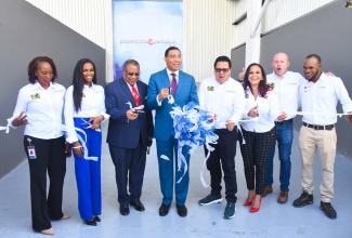 Prime Minister, the Most Hon. Andrew Holness (fourth left), cuts the ribbon symbolising the official opening of Pepsi Cola Jamaica’s new US$30million state-of-the-art production line at the company’s Spanish Town Road plant in Kingston on Tuesday (November 7). Joining him (from left) are Pepsi Cola Jamaica Logistics Manager, Cassandra Miller Bent, and Transformation Manager, Anecia Levy; Member of Parliament, St. Andrew Western, Anthony Hylton; and Pepsi Cola Jamaica’s General Manager, Alberto Ramirez; Commercial Manager, Luz Tejada; Plant Manager, Eisner Blandino Gomez; and Manufacturing Chief, Javon Salmon.

