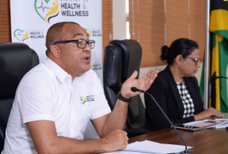Minister of Health and Wellness, Dr. the Hon. Christopher Tufton, addresses a press conference at his New Kingston offices, today (November 9). Pictured at right is Chief Medical Officer (CMO), Dr. Jacquiline Bisasor-McKenzie.