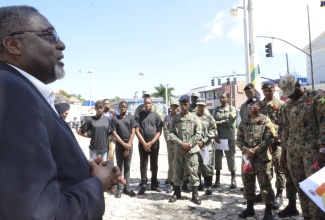 Custos Rotulorum for St. James, Bishop the Hon. Conrad Pitkin (left), addresses members of the Jamaica Defence Force (JDF) and Cadet Corps during a recent poppy appeal activity in Sam Sharpe Square, Montego Bay.