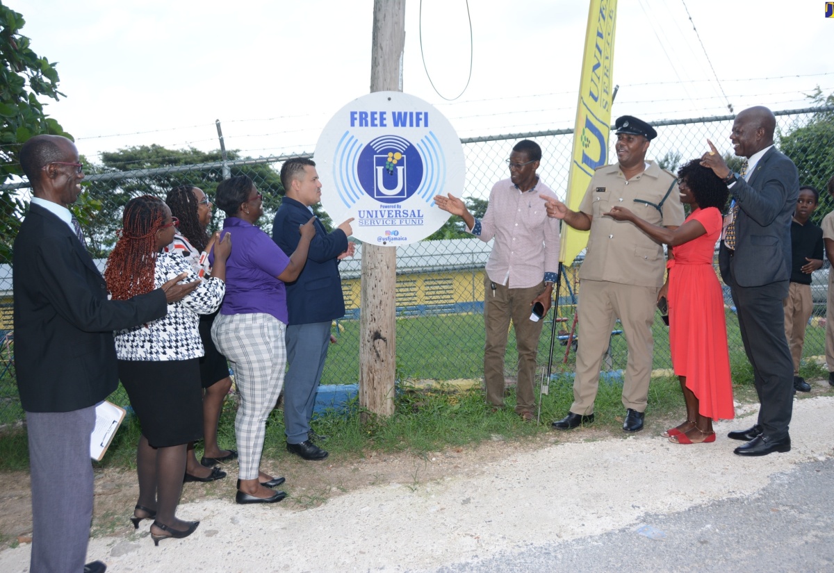 Minister without Portfolio in the Ministry of Economic Growth & Job Creation (MEGJC), Senator the Hon. Matthew Samuda (fifth left) and Chief Executive Officer, Universal Service Fund (USF), Daniel Dawes (right), are joined by education, law-enforcement and community stakeholders at the launch of free community Wi-Fi in Edgehill, St. Ann, on Tuesday (November 7).