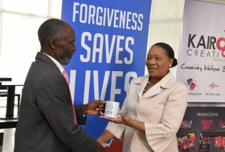 Spokesperson for the ‘Forgiveness Saves Lives’ public education campaign, Silton Townsend (left), presents Deputy Chief Education Officer, Curriculum and Services Division, Ministry of Education and Youth, Dr. Clover Hamilton-Flowers with a mug during the campaign launch on November 15 at the Courtyard Marriott in Kingston. The initiative, which is being undertaken by local advocacy and non- profit group ‘Hello Neighbour’ in partnership with several church denominations in Jamaica, aims to garner the support of the Government, businesses, organisations, church, and civil society groups in promoting peace in society.