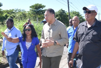  Prime Minister, the Most Hon. Andrew Holness (centre)  tours sections of St. Thomas today (November 19) to assess the aftermath of the heavy rains, which affected the island recently. With the Prime Minister are, from second left, Member of Parliament (MP), St. Thomas Eastern, Dr. Michelle Charles; St. Thomas Western MP, James Robertson; and Councillor, Dalvey Division, Michael Mcleod.