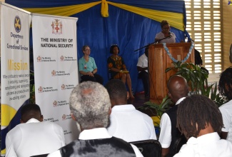 Minister of State at the National Security Ministry, Hon. Juliet Cuthbert-Flynn (at podium), addresses the recent graduation of inmates and correctional officers from the Entertainment Business Certificate programme under the University of the West Indies (UWI) Mona Prison Project (UMPP), held at the Tower Street Adult Correctional Centre in Kingston.