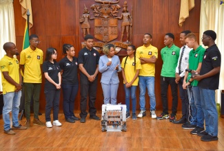 Minister Without Portfolio with Responsibility for Skills and Digital Transformation, Senator Dr. the Hon. Dana Morris Dixon (centre), congratulates members of Jamaica’s team copping Gold in the Robotics Olympics, which took place in Singapore from October 7 to 10. Minister Morris Dixon met with the members during their courtesy call at Jamaica House on Tuesday (October 31).

