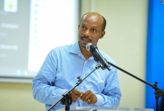 Acting Communications and Public Affairs Manager at the National Water Commission (NWC), Charles Buchanan, addresses the National Disaster Risk Management Council meeting held on Tuesday  (October 31) at the Ministry of Local Government and Community Development’s Hagley Park Road offices.