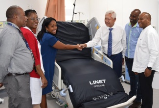 Acting Chief Executive Officer, University Hospital of the West Indies (UHWI), Fitzgerald Mitchell (left), along with (from second left), Nurse Manager, Intensive Care Unit (ICU) and Recovery Room, UHWI, Marsha Downer-Campbell; Representative from Medical Link Limited, Paula Walker; Board Chairman, UHWI, Wayne Chai Chong; Chief Executive Officer, Medical Link Limited, Lainsworth Walker, and Head of the ICU UHWI, Dr. Kelvin Metalor, accepts an ICU Bed donated by Medical Link Limited and the LINET Group, during a ceremony held at the institution in Kingston on Tuesday (November 21). LINET’s new premium high-end intensive care bed features a frame-based lateral tilt solution, developed to help patients recover faster and reduce physical strain on medical personnel. Together with Smart Care Solution, they contribute to more efficient medical care and reduction of administrative tasks.

