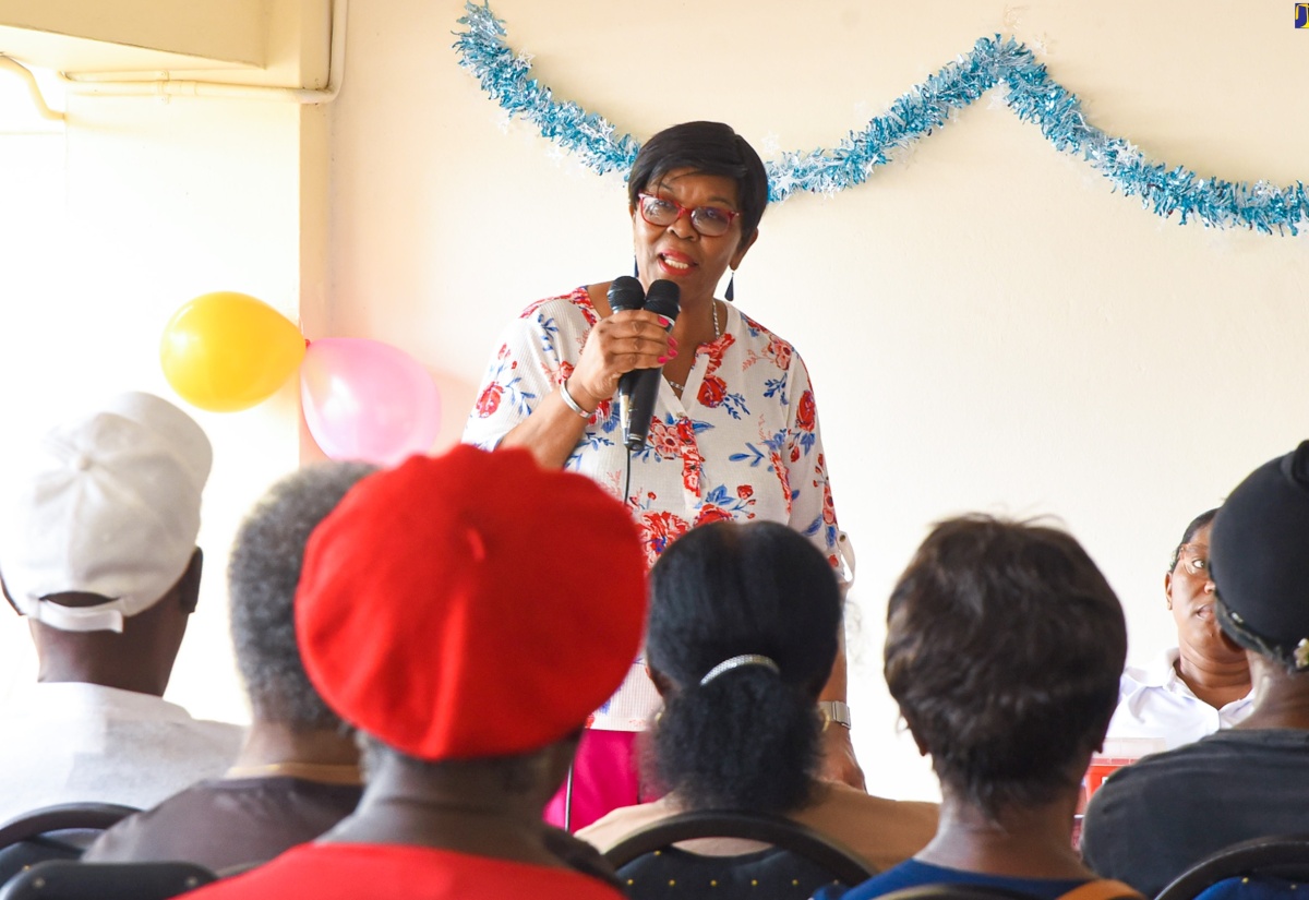 Clerk to the Houses of Parliament, Valrie Curtis, addresses the audience at the annual Elderly Treat and Health Fair on December 13 at Gordon House. Approximately 100 elderly persons who reside at Mark Lane and surrounding communities, downtown Kingston, received care packages containing food items and toiletries. The annual event returned this year after a hiatus due to the COVID-19 pandemic.

