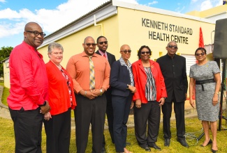 Minister of Education and Youth and Member of Parliament for St. Andrew Eastern, Hon. Fayval Williams (fourth right), attends Thursday’s (December 14) renaming ceremony for August Town/Hermitage Health Centre in the constituency. The facility’s name has been officially changed to the Kenneth Standard Health Centre, in honour of the late Jamaican medical doctor who was a cornerstone of public health development locally and regionally and made tremendous contributions to community medicine throughout the Caribbean. Also attending are (from left) Pro-Vice Chancellor and Principal of the University of the West Indies Mona Campus, Professor Densil Williams; Executive Director, Mona Ageing and Wellness Centre, Professor Denise Eldemire-Shearer; family members of the honouree – Dr. Marlon Lloyd Goldson, Christopher Lloyd Goldson, and Dr. Aileen Standard-Goldson; and Chief Medical Officer in the Ministry of Health and Wellness, Dr. Jacquiline Bisasor McKenzie.


