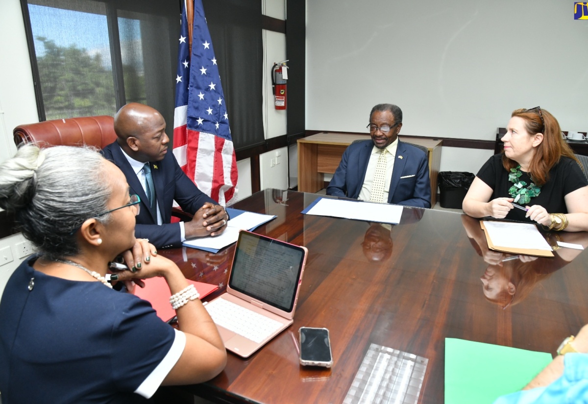 Minister of Labour and Social Security, Hon. Pearnel Charles Jr. (second left), listens to United States Ambassador to Jamaica, His Excellency, Noah Nick Perry (second right), during a meeting at the Ministry’s Heroes Circle offices in downtown Kingston on December 19. The Minister engaged Mr. Perry in discussions surrounding labour and social security matters. Looking on (from left) are Permanent Secretary in the Ministry, Colette Roberts Risden and Consul General, United States Embassy, Ann Marie Chiappetta.

