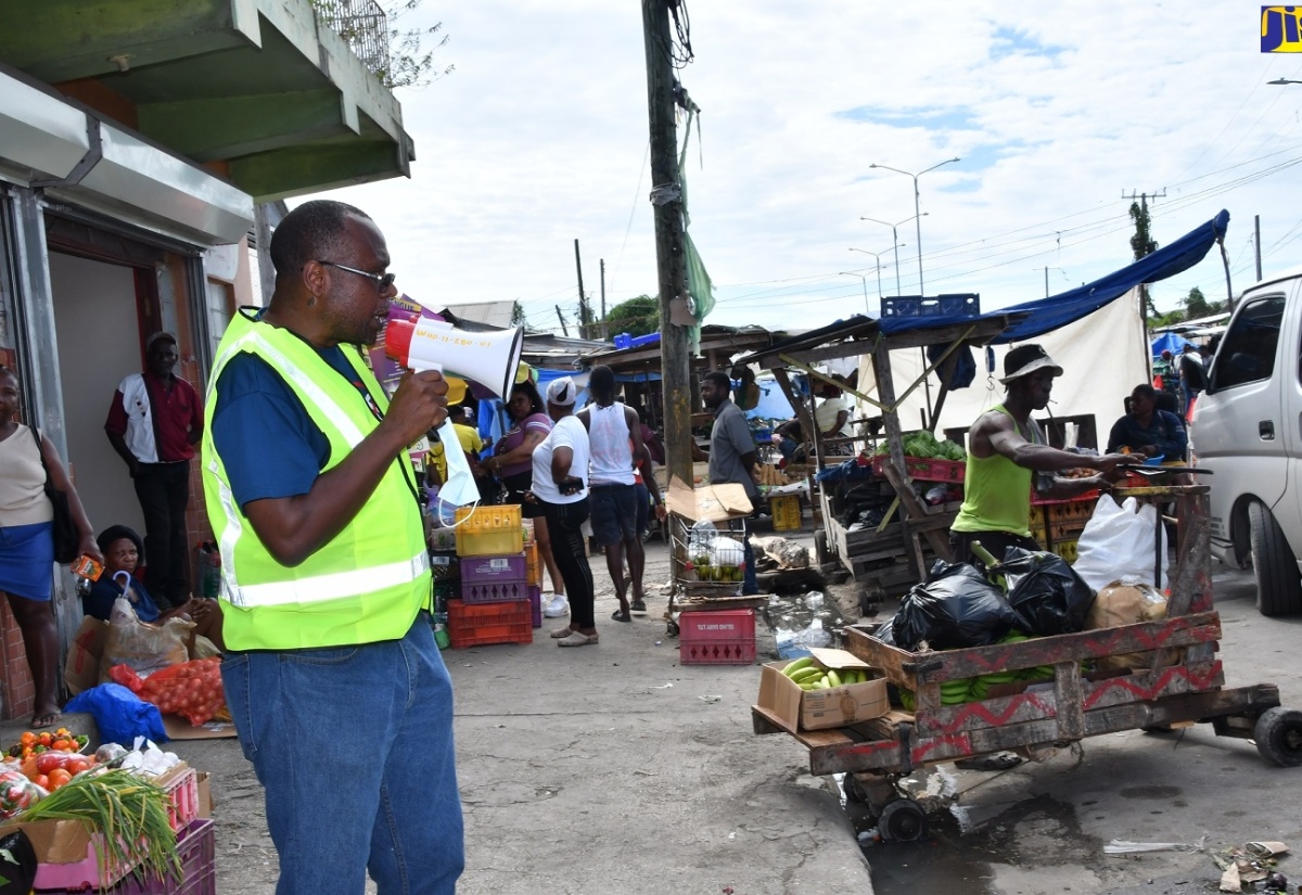 Health Promotion and Education Officer, Westmoreland Health Department, Gerald Miller, addresses residents of Savanna-la-Mar during a dengue fever public education initiative in the town on December 15.

