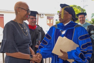 Minister of Education and Youth, Hon. Fayval Williams, is greeted by newly appointed President of the Caribbean Graduate School of Theology, Dr. Anthony Oliver, prior to his taking the oath of office during the institution’s Presidential Installation and Graduation Ceremony, on Saturday (December 2). Minister Williams delivered greetings during the ceremony, which was held at the Church of the Open Bible on Washington Boulevard in Kingston.

