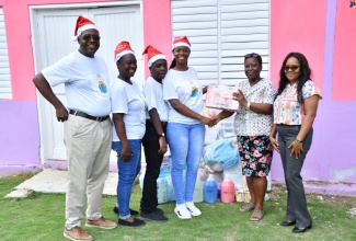 Assistant Matron of the Westmoreland Infirmary, Lorna Gifford (second right) and Assistant Poor Relief Officer for the Westmoreland Municipal Corporation, Angella Morris (right), accept a donation from University of Technology (UTech) Jamaica student, Geri-Ann Miller (fourth left), on December 28. Also taking part in the presentation are Ms. Miller’s family members (from left): father, Gerald Miller; mother, Andrea Miller and brother, Anthony Miller. Among the items donated were adult diapers, toiletries, soaps, and detergent.

 