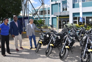 Deputy Prime Minister and Minister of National Security, Hon. Dr. Horace Chang (right), along with (from left) Head, Corporate Communications Unit, Jamaica Constabulary Force (JCF), Senior Superintendent of Police, Stephanie Lindsay and Deputy Commissioner of Police, Fitz Bailey, at the handover of 74 new bikes, valued at $63.913 million, to the Public Safety and Traffic Enforcement Branch (PSTEB), at the Office of the Police Commissioner in Kingston, on December 1.