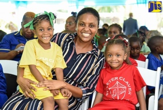 Chair, Early Childhood Commission (ECC), Trisha Williams-Singh, interacts with St. Peter Claver Primary and Infant School students Arianna Temple (left) and Kimarney Allen, during the launch of Sagicor Foundation’s 2019/20 Adopt-A-School programme at Hope Gardens in St. Andrew, in 2019.

