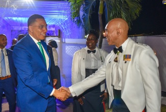Prime Minister the Most Hon. Andrew Holness (left) is greeted by Commissioner of Police, Major General Antony Anderson, on arrival at the Police Officers’ Club in St. Andrew on Saturday (Dec. 9), for the Jamaica Constabulary Force’s  (JCF) annual officers’ cocktail party.
