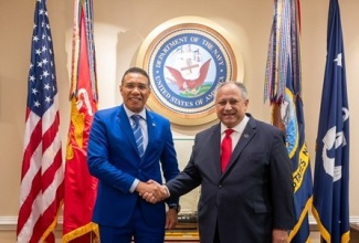 Prime Minister, the Most Hon. Andrew Holness (left), is welcomed to the Pentagon by Secretary of the Navy, Carlos Del Toro, prior to holding bilateral talks on national safety and security this week.

