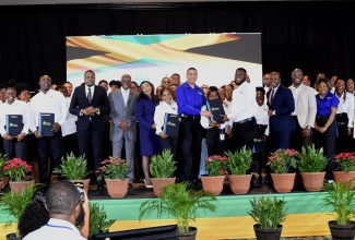 Prime Minister, the Most Hon. Andrew Holness (ninth left, front row), with Clarendon participants in the Government’s Learning and Investment for Transformation (LIFT) Programme at a social advancement ceremony, held at The Jamaica Pegasus hotel, in Kingston, on December 15. Also with the participants are (from fifth left, front row): Minister without Portfolio in the Office of the Prime Minister with Responsibility for Information and Member of Parliament (MP) for Clarendon North Central, Hon. Robert Morgan; Chairman of the Board of Directors, HEART/NSTA Trust, Professor Alvin Wint; Managing Director of the HEART/NSTA Trust, Dr. Taneisha Ingleton; Minister of Labour and Social Security and MP for Clarendon South Eastern, Hon. Pearnel Charles Jr.; Clarendon Northern MP, Dwight Sibbles; and Minister without Portfolio in the Office of the Prime Minister with responsibility for Skills and Digital Transformation, Senator Dr. the Hon. Dana Morris Dixon.

