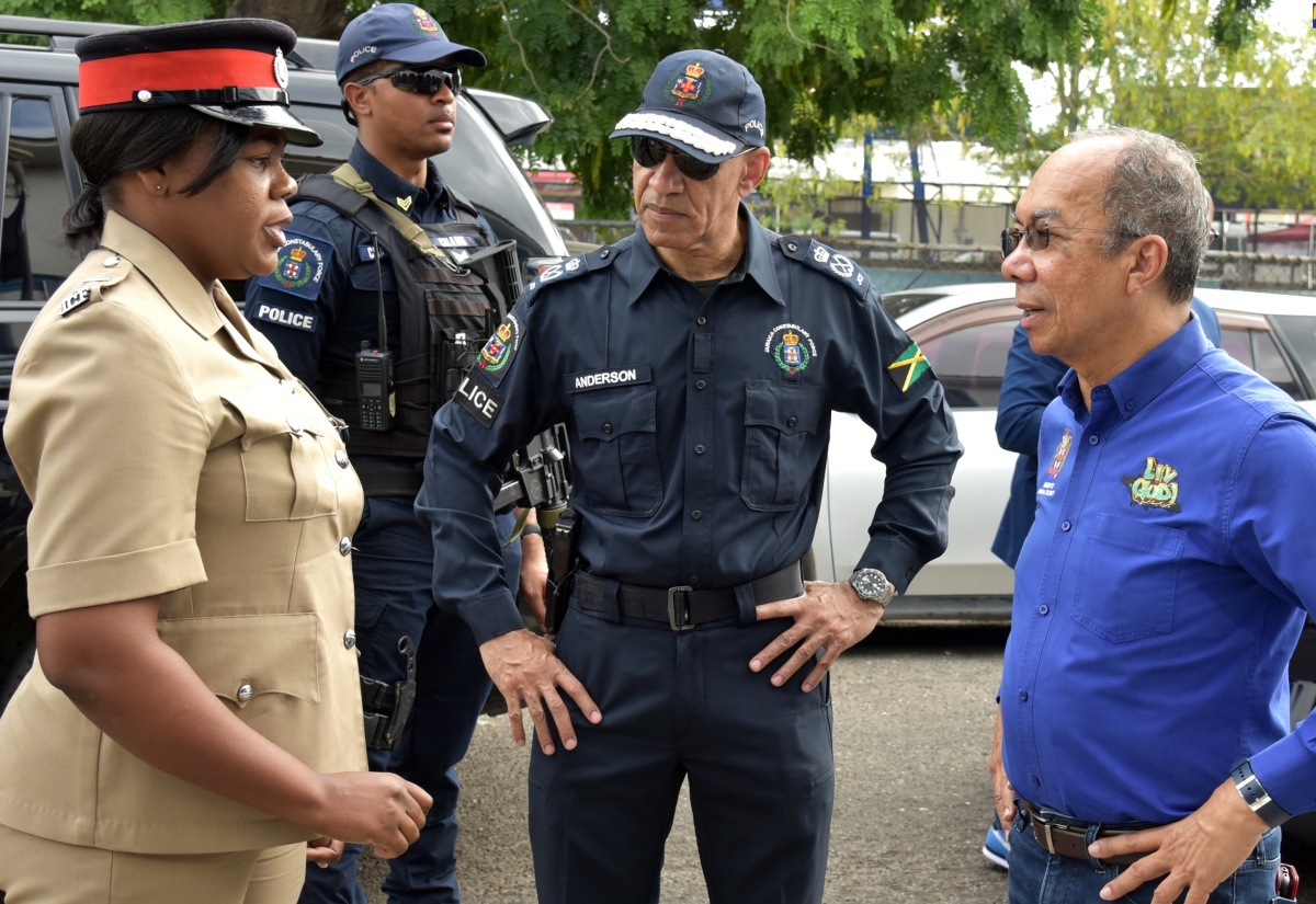 Minister of National Security and Deputy Prime Minister, Hon. Dr. Horace Chang (right), speaks with Inspector Yuana Roberts (left) of the Cross Roads Police Station. Listening is Commissioner of Police, Major General Antony Anderson. The Minister toured several police stations and business centres in the Corporate Area on Thursday (December 21), to observe activities and reassure business owners and shoppers of the police’s presence during the busy holiday period.

