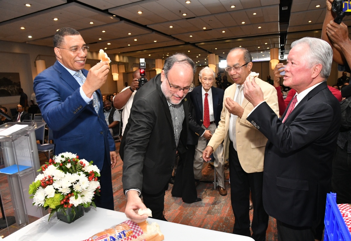Prime Minister, the Most Hon. Andrew Holness (left) breaks bread with (from second left), Opposition Leader Mark Golding; Minister of National Security, Hon. Dr. Horace Chang and Chairman of National Baking Company Limited, Butch Hendrickson. Occasion was the announcement ceremony for National Baking Company Limited’s new $6.7-billion Bread Plant, held on Monday (January 8) at the Hilton Hotel and Spa in Rose Hall, St. James. 