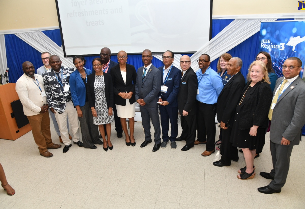 Minister of Education and Youth, Hon. Fayval Williams (seventh left), shares a photo opportunity with members of the Institute of Electrical and Electronics Engineers (IEEE) team, during Wednesday’s (January 17) opening session of the IEEE workshop, held at the University of Technology, Jamaica (UTech), in St. Andrew.
