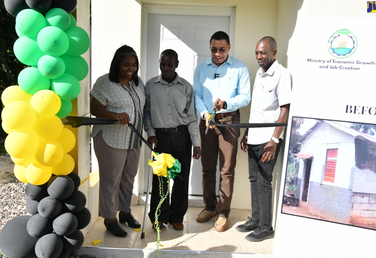 Prime Minister, the Most Hon. Andrew Holness (second right), cuts the ribbon to formally hand over a one-bedroom unit under the New Social Housing Programme (NSHP) to beneficiary, Wellesly McKenzie (second left) of Lacovia in St. Elizabeth on Friday (January 12). Looking on are (from left) Chair, Oversight Committee, NSHP, Judith Robb; and Minister of State in the Ministry of Science, Energy, Telecommunications and Transport and St. Elizabeth North Western Member of Parliament, Hon. William James Charles (J.C.) Hutchinson.