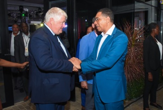 Prime Minister, the Most Hon. Andrew Holness (right), greets Digicel Founder, Denis O’Brien, during a reception held in his honour at the AC Hotel by Marriott Kingston on Tuesday (January 9).

