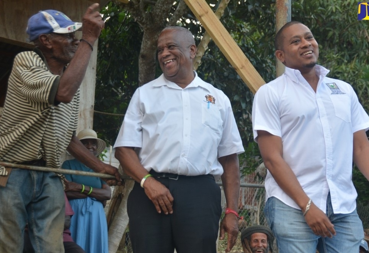 Minister of Agriculture, Fisheries and Mining, Hon. Floyd Green (right), and Minister of State in the Ministry of Agriculture, Fisheries and Mining, Hon. Franklin Witter (centre), interact with farmer Errol Reid during a visit to the Welcome Hall community in South St. James on Thursday, January 17.