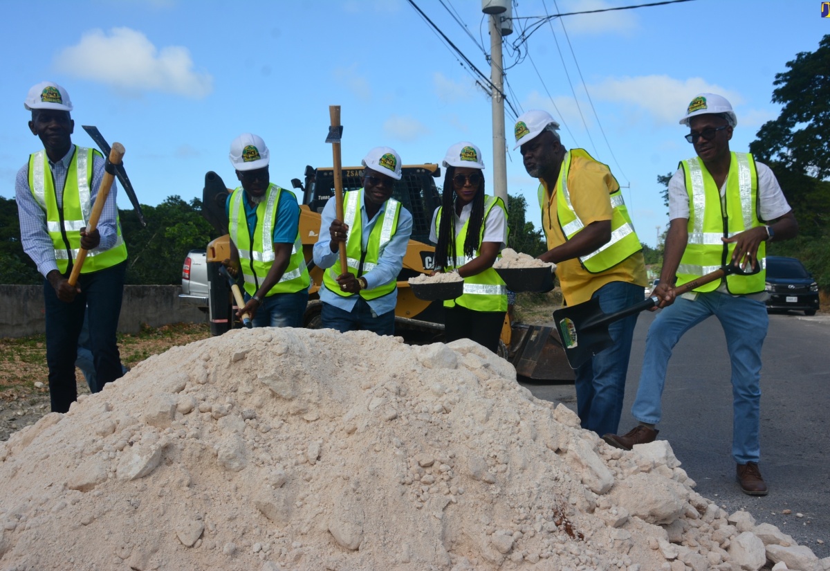 Minister of Economic Growth and Job Creation, Hon. Everald Warmington (third left), breaks ground for the rehabilitation of the Holland to Bounty Hall road in Trelawny on Thursday (Jan.18). He is joined by (from left) Bishop Dalton Collins; Communications and Customer Services Manager of the National Works Agency (NWA), Stephen Shaw; Member of Parliament for Trelawny Northern, Tova Hamilton; Contractor Morris Hill; and NWA’s Regional Manager (West), Robert Francis.