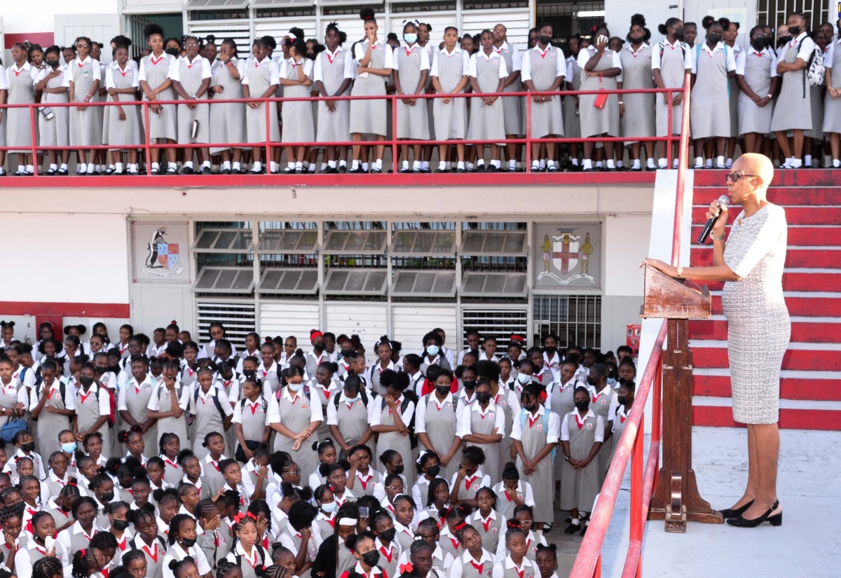 Minister of Education and Youth, Hon. Fayval Williams (at podium), addresses students of The Queen’s School in Kingston, during a visit on January 8 to usher in the new school term.

