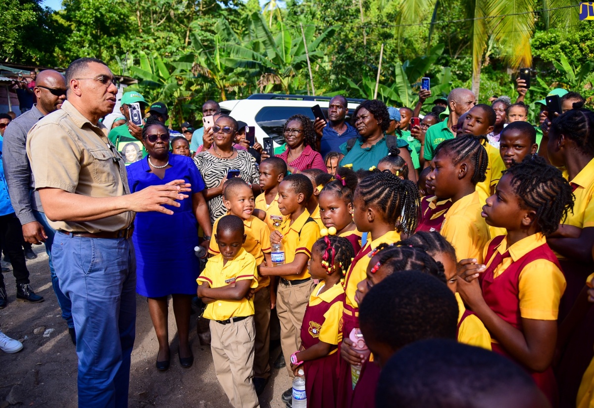 Prime Minister, the Most Hon. Andrew Holness (left), addresses students and teachers of the Jubilee Town Primary School in Berkshire, St. Catherine, on January 18, where he handed over a two-bedroom unit under the New Social Housing Programme (NSHP).

