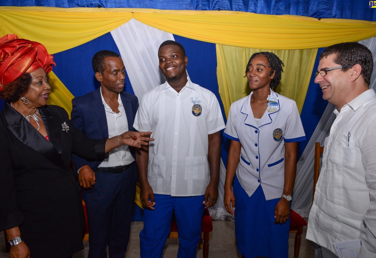 Social Historian and Director of the Centre for Reparation Research at the University of the West Indies (UWI), Mona, Professor Verene Shepherd (left), engages with (from second left) businessman and past student, José Martí Technical High School, Rohan Silvera; students Tamera Jarrett and Laterell McKenzie; and Cuban Ambassador to Jamaica, His Excellency Fermin Quiñones Sánchez. Occasion was the school’s 47th Founder’s Day Celebrations and Awards ceremony held on January 10, at the St. Catherine-based institution.

