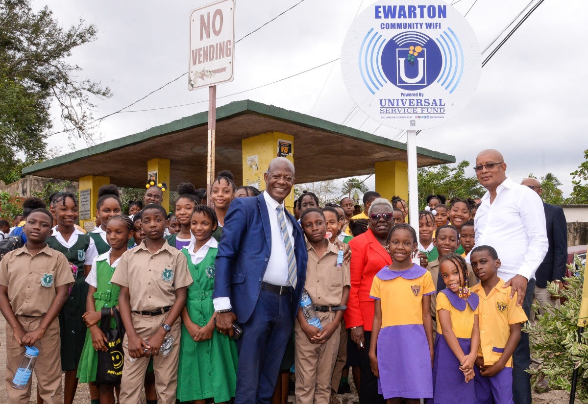 Chief Executive Officer, Universal Service Fund (USF), Daniel Dawes (front centre), is joined by Councillor for the Ewarton Division, Beverly Jobson-Grant (fifth right); Mayor of Spanish Town, Councillor Norman Scott (right); and school children, at the Ewarton community Wi-Fi launch in St. Catherine on January 25.