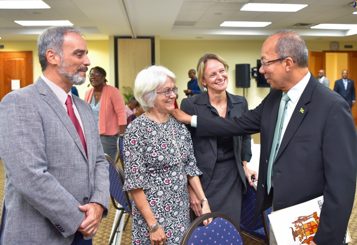 Deputy Prime Minister and Minister of National Security, Hon. Dr. Horace Chang (right), greets Chairman of the Violence Prevention Alliance (VPA), Professor Elizabeth Ward (second right) during the closing-out ceremony for the review of the technical assistance to the Citizen Security Plan (CSP), at the University of the West Indies Regional Headquarters on January 25. Sharing in the moment (from left) are International Aid/Programme Manager Cooperation Section, Delegation of the European Union to Jamaica, Luca Lo Conte and Violence Prevention and Citizen Security Expert, Heather Sutton.