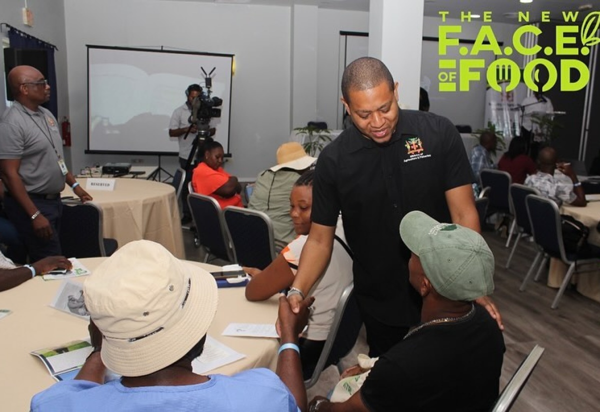 Minister of Agriculture, Fisheries and Mining, Hon. Floyd Green (right), greeting Westmoreland farmers on arrival at ‘The New Face of Food: Stakeholder Engagement’, in the parish on January 19.

