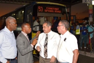 Minister of Science, Energy, Telecommunications and Transport and Mining Hon. Daryl Vaz (r) in discussion with (from left) Chairman of the Transport Authority (TA) Mr. Owen Ellington, TA Managing Director Mr. Ralston Smith, Managing Director of the Jamaica Urban Transit Company Mr. Paul Abrahams at the Half-Way-Tree Transport Centre on Monday January 9. Minister Vaz toured the Transport Centre to observe operations following the implementation of a temporary reduction in bus fares on January 1, 2023. 

